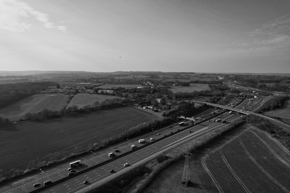 Aerial view of an English motorway through open fields