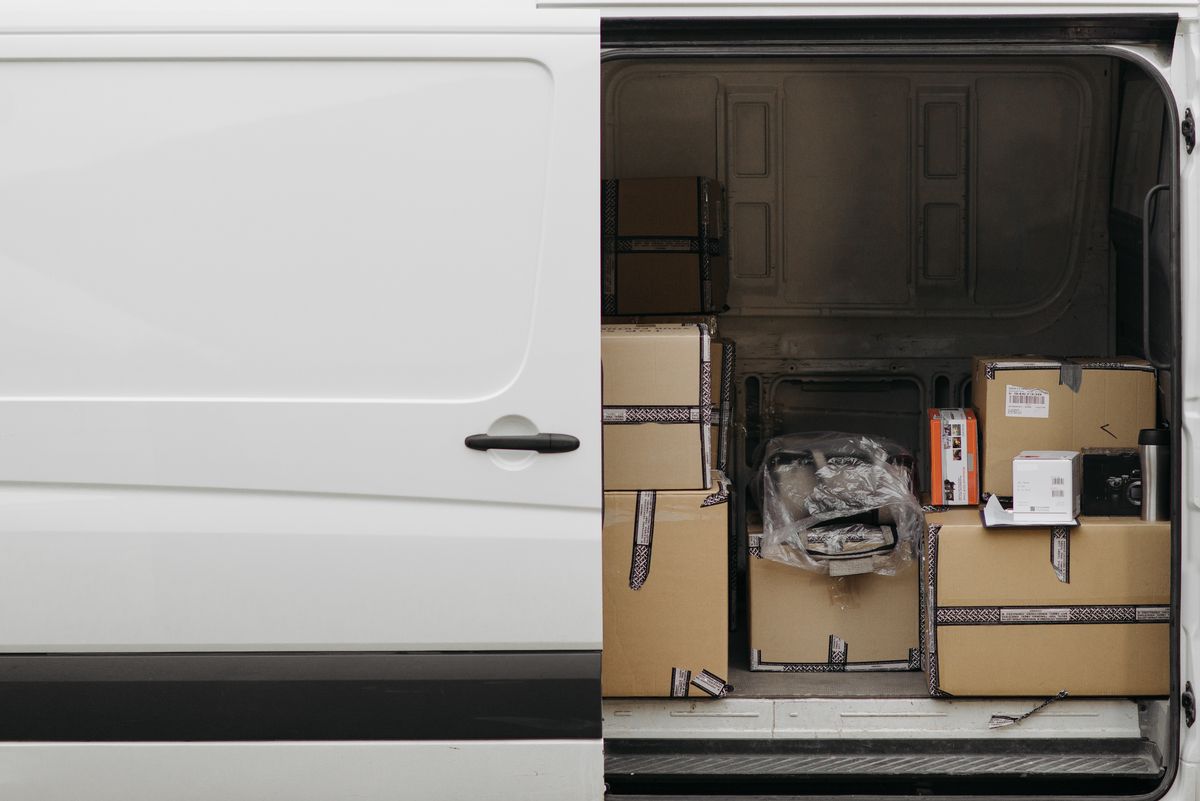 Open van side door loaded with parcel boxes